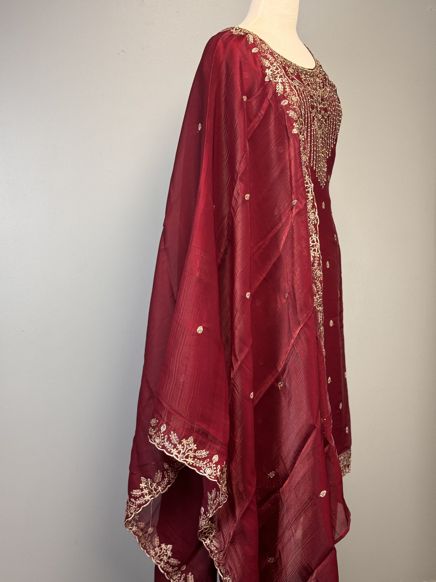 Maroon Salwar Suit with Golden Bead Accents.