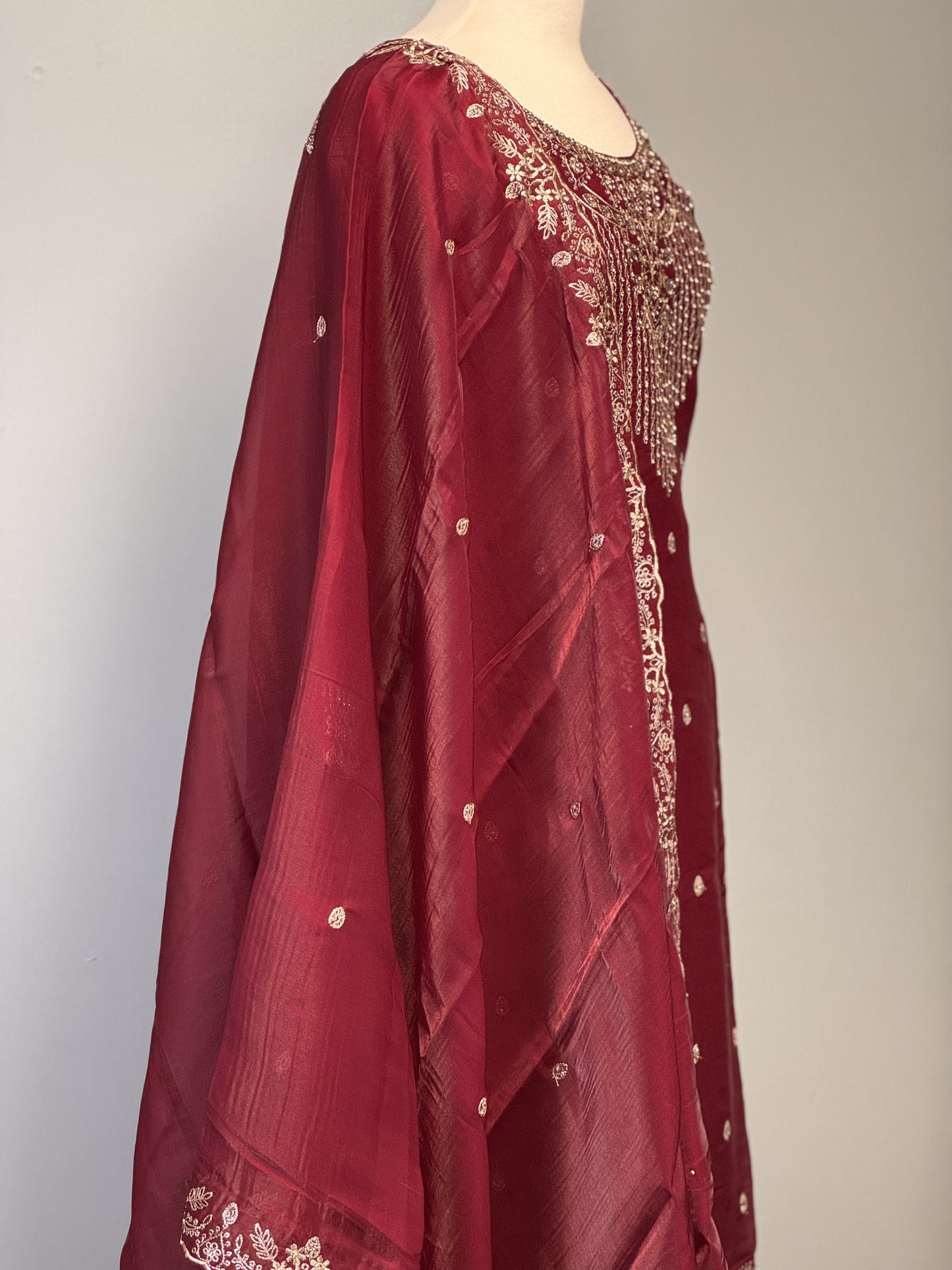 Maroon Salwar Suit with Golden Bead Accents.