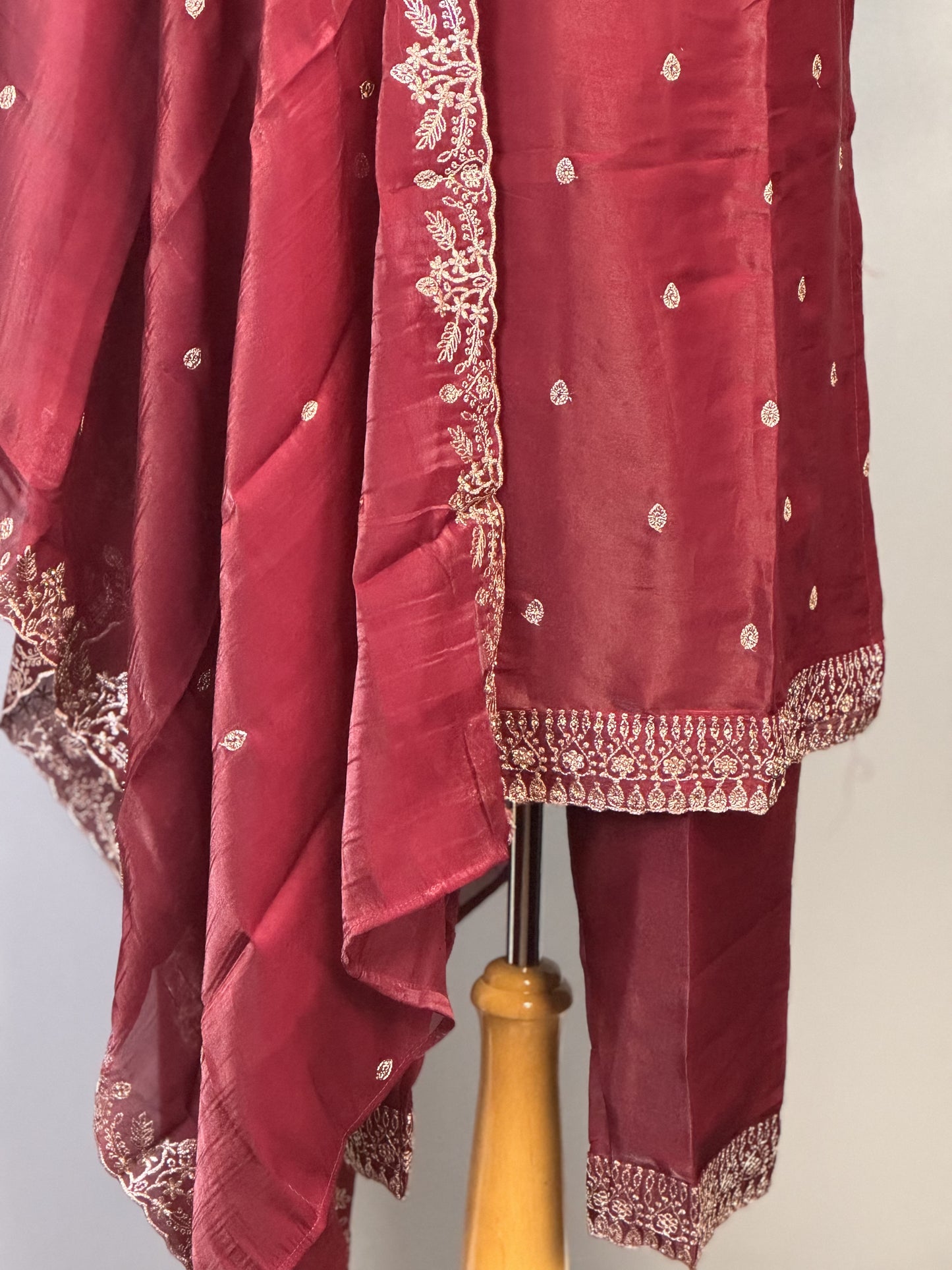 Adorned Maroon Salwar Suit with Golden Bead Accents.