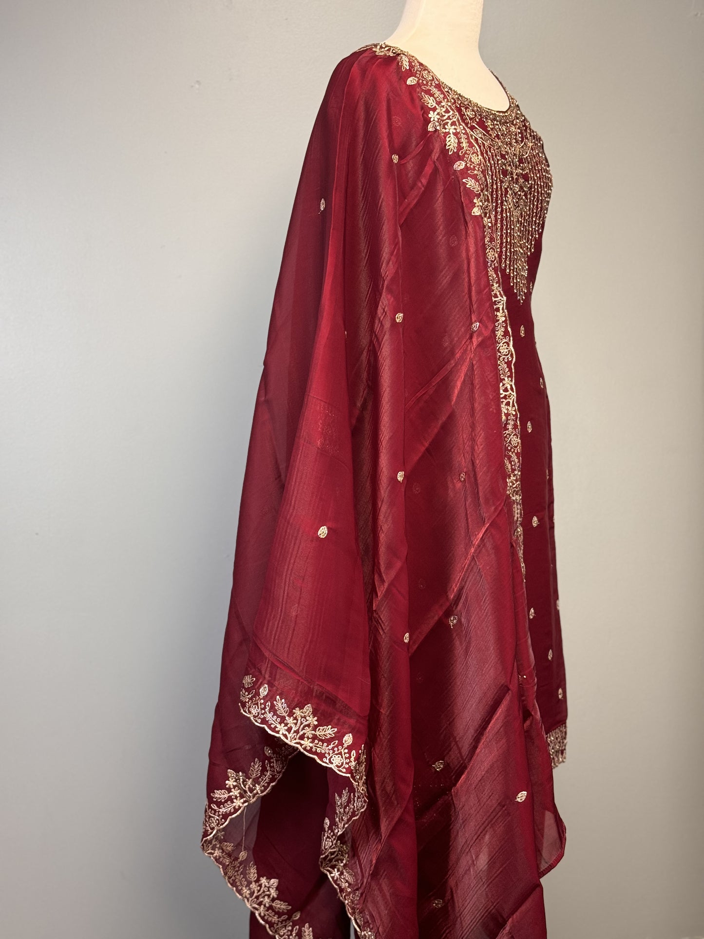 Adorned Maroon Salwar Suit with Golden Bead Accents.