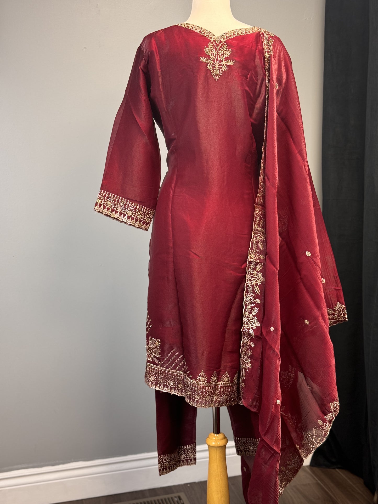 Adorned Maroon Salwar Suit with Golden Bead Accents.