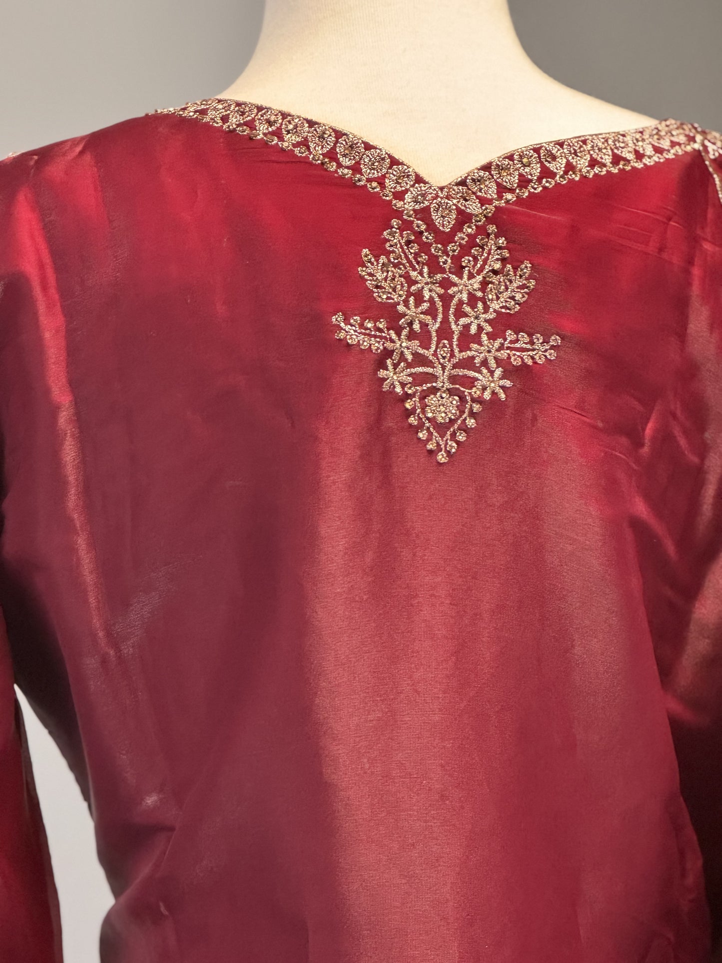 Adorned Maroon Salwar Suit with Golden Bead Accents.